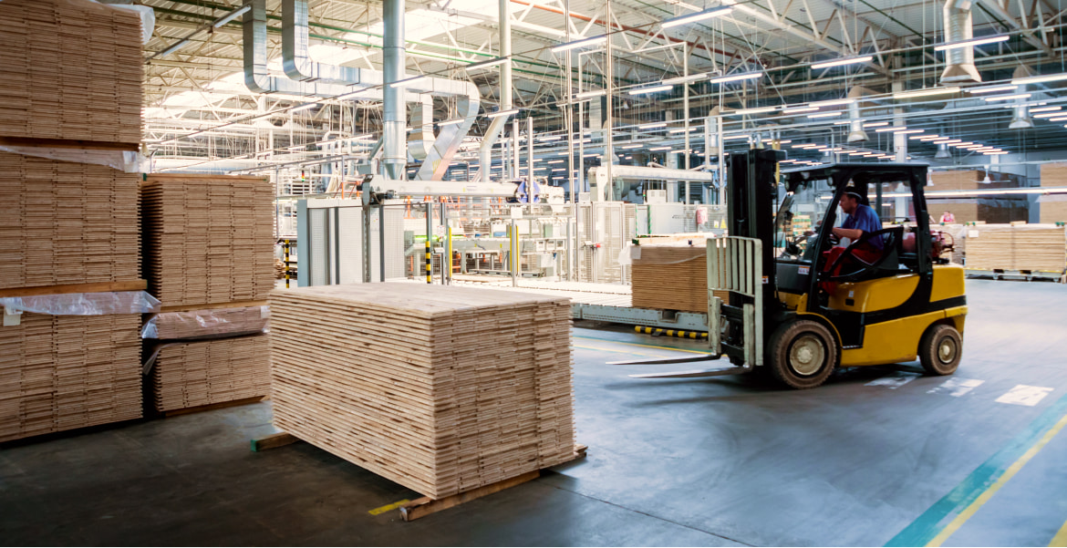 Warehouse with forklift and lumber stacks